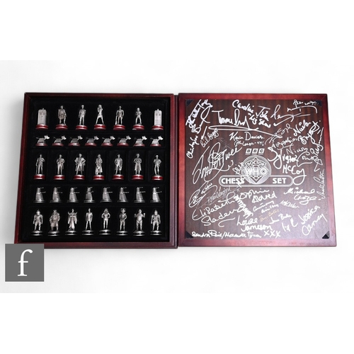 106 - A signed Doctor Who pewter chess set by the Danbury Mint, signed by previous Doctors, companions and... 