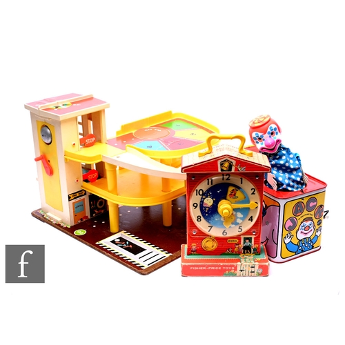 132 - A vintage Fisher Price garage, a Fisher Price clock, circa 1960s, and Mattel tinplate Jack in the bo... 