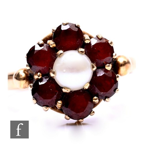 127 - A 9ct hallmarked cultured pearl and garnet cluster ring, central pearl within a seven garnet surroun... 