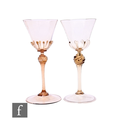 144 - A near pair of 20th Century Venetian wine glasses, with brown fume glass flared octagonal bowls, on ... 