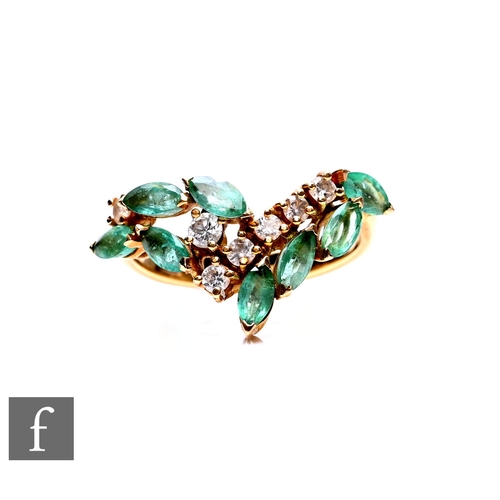 64 - An 18ct hallmarked emerald and diamond ring with a row of seven brilliant cut diamonds with marquise... 