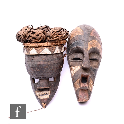 576 - An African Salampasu mask from the Democratic Republic of the Congo, the carved wood with woven deco... 