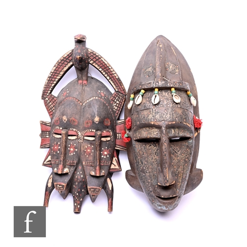 577 - An African Bambara mask from Mali, the carved wood mounted with pattered brass panels completer with... 