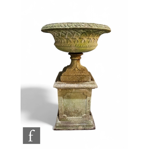 1112 - A large 20th Century composite stone garden terrace urn, with lattice border on a trumpet base and s... 