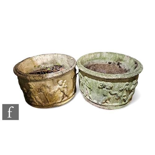 1113 - A large pair of circular planters, decorated with cherubs bathing and holding bunches of grapes belo... 