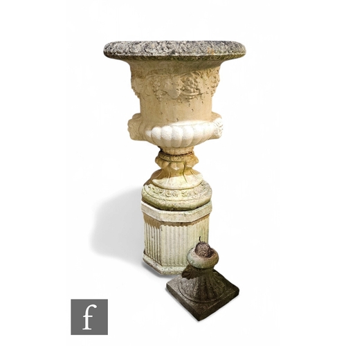 1114 - A late 20th Century terrace urn, the fluted top over a border of grapes and double side twin mask he... 