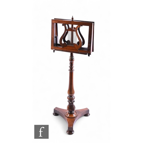 1041 - A 19th Century mahogany music stand, the adjustable lyre shaped top over a turned baluster pedestal,... 