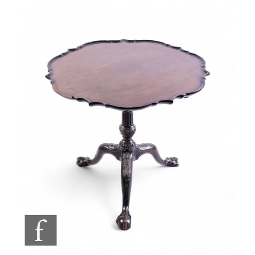 1068 - A George III style mahogany tilt top occasional table, the piecrust edge top over a bird cage action... 