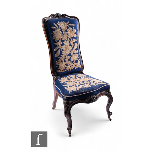 1075 - A Victorian carved rosewood prieux deux chair, floral scroll back on cabriole legs, upholstered in f... 