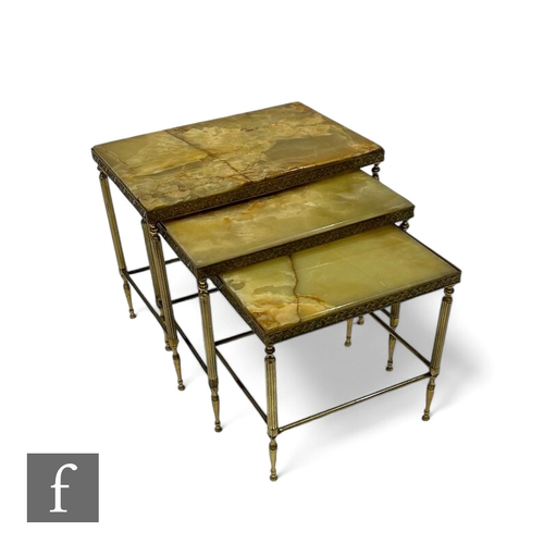 1086 - A nest of three onyx and gilt metal occasional tables, the largest 55cm. (3)