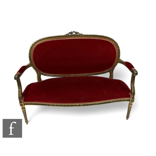 1087 - A 20th Century French gilt three seater salon settee, carved oval panel back above down swept arms o... 