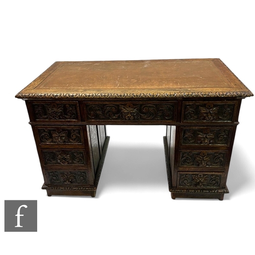 1090 - A Victorian carved oak kneehole pedestal desk, brown tooled leather inset top over three lion mask h... 