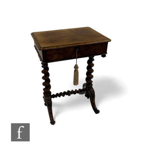 1095 - A Victorian figured walnut work table, the top opening to reveal a compartmentalised interior on spi... 