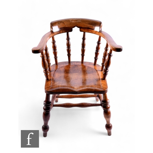 1099 - A 19th Century smoker's bow chair, turned spindle back, on splayed legs.