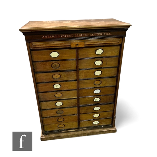 1103 - An Edwardian walnut floorstanding office filing cabinet fitted with eighteen drawers enclosed by a t... 