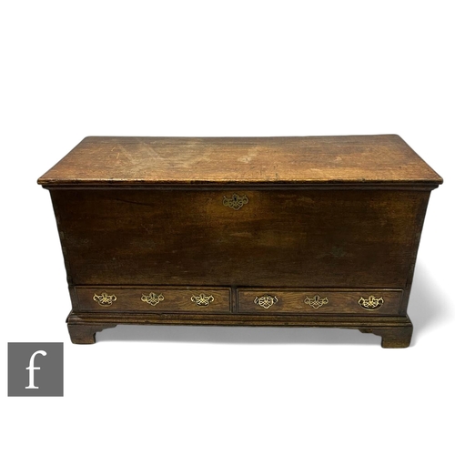 1080 - A George III oak mule chest, the moulded edge hinged top over two short drawers, on bracket feet, he... 