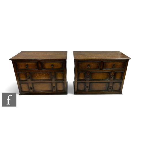 1097 - A pair of 1930s oak chests of two short and three long drawers, brass pear drop handles, below mould... 