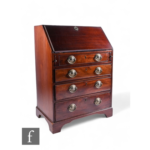 1045 - A small George III mahogany bureau, fitted drawer and pigeon hole interior enclosed by a fall over f... 