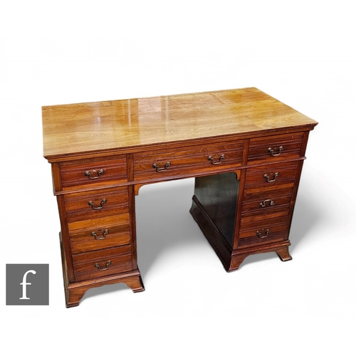 1050 - An Edwardian walnut kneehole desk/dressing table fitted with three frieze drawers and three further ... 