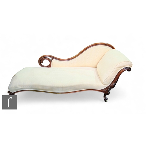 1055 - A Victorian double carved mahogany scroll back chaise longue, serpentine front on cabriole legs, uph... 