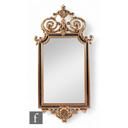 1073 - A 20th Century rectangular gilt pier mirror with deep scroll acanthus pediment over section panels a... 