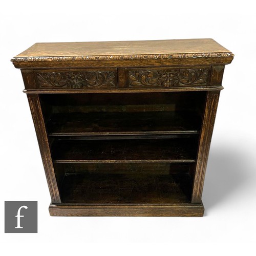 1081 - A Victorian carved oak open bookcase fitted with two upper drawers, lion mask handles, reeded pilast... 