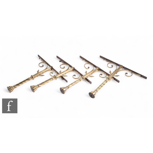 1092 - A set of four 19th Century brass alter rail brackets of spiral and scroll design, height 57cm. (4)