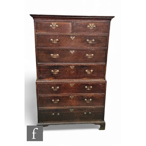 1061 - A George III oak chest on chest, the upper section fitted with two short and three drawers on a base... 