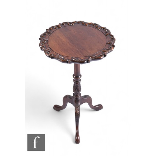 1108 - A small mahogany tripod occasional table, the craved circular top over a turned pedestal on splayed ... 