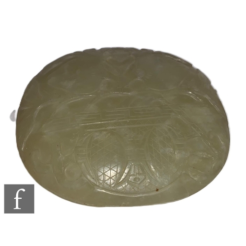 514 - A Chinese late Qing Dynasty green hardstone carving of circular form with a flat back, carved with f... 