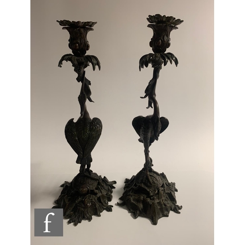 529 - A pair of Japanese Meiji period (1868-1912) candlesticks, modelled as cranes standing on tortoises a... 