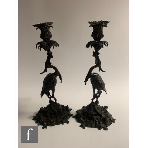 529 - A pair of Japanese Meiji period (1868-1912) candlesticks, modelled as cranes standing on tortoises a... 