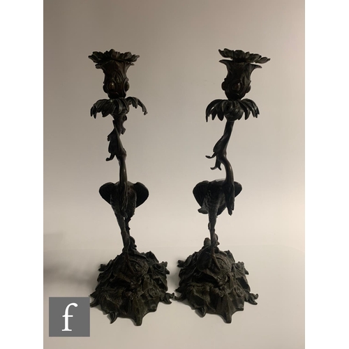 529 - A pair of Japanese Meiji period (1868-1912) candlesticks, modelled as cranes standing on tortoises a... 