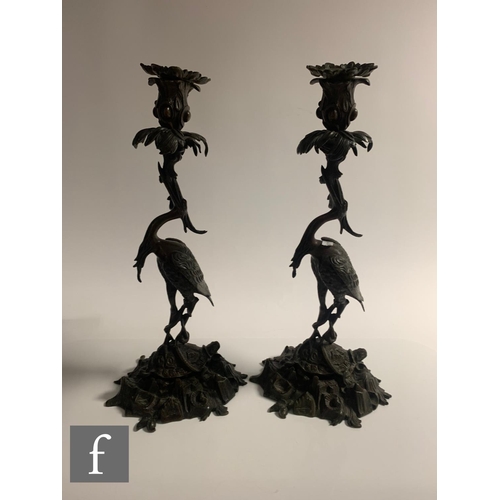 529 - A pair of Japanese Meiji period (1868-1912) candlesticks, modelled as cranes standing on tortoises a... 