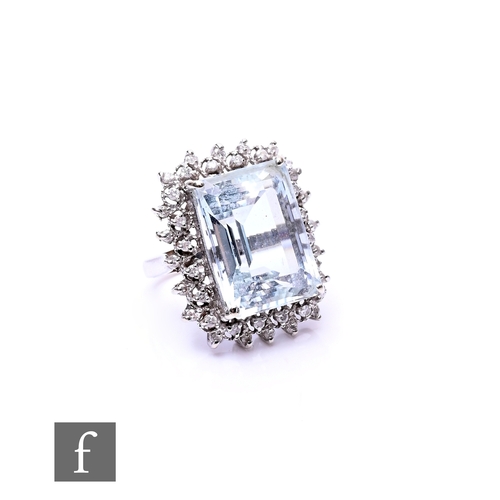 70 - A 14ct white gold aquamarine and diamond cluster ring, central claw set aquamarine, length 18mm, wid... 