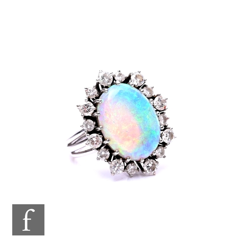 71 - An 18ct white gold opal and diamond cluster ring, central oval opal, length 15mm, within a border of... 