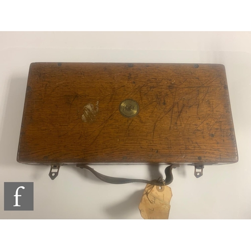 637 - A 19th Century oak pistol case with green felt divisioned interior, labelled James Woodward London, ... 