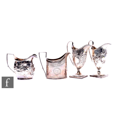 373 - Four assorted Georgian hallmarked silver cream jugs to include helmet and boat shaped examples, tota... 