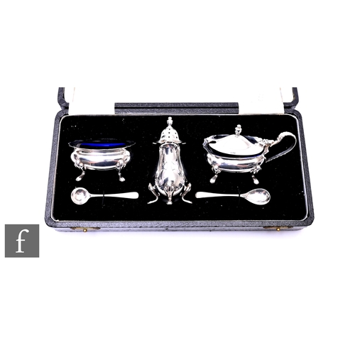 438 - A cased hallmarked silver three piece, boat shaped cruet set each raised on four pad feet, weight of... 