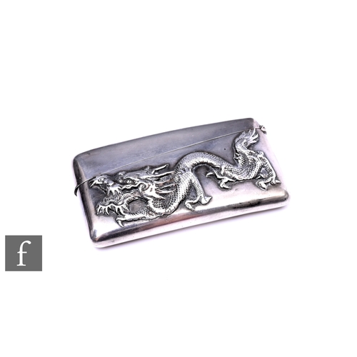 444 - An early 20th Century Chinese silver clapperboard card case with a study of a dragon to the front, w... 