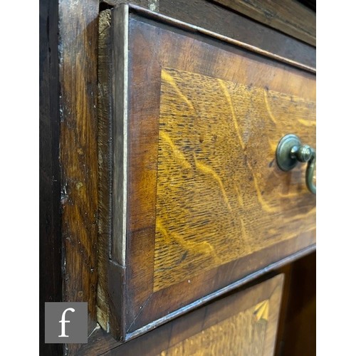 85 - A George III mahogany crossbanded oak kneehole dressing chest fitted with a single long drawer below... 