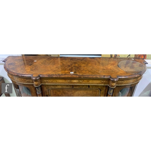 1085 - A 19th Century figured marquetry inlaid walnut credenza enclosed by an arched framed door flanked by... 