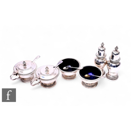 450 - A mid 20th Century silver condiment set to comprise a pair of mustard pots with acanthus leaf scroll... 