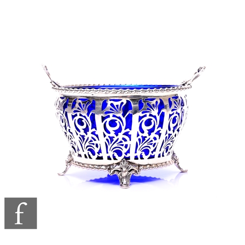 452 - An early 20th Century twin handled pierced silver sugar bowl with foliate detail, raised to four scr... 