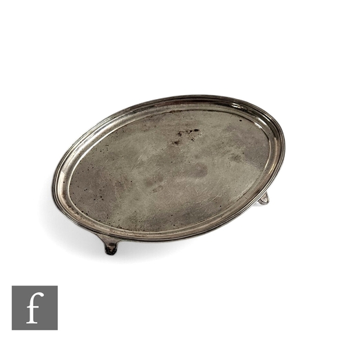 453 - A George III silver oval card waiter, with ribbed border and raised to four feet, width 18cm, weight... 