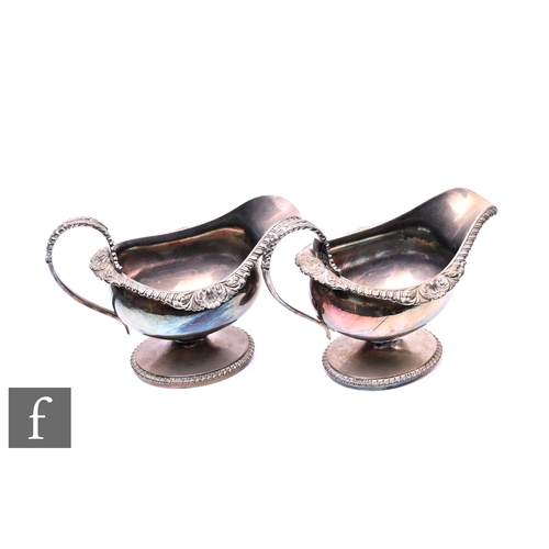 458 - A pair of George III silver sauce boats, with acanthus scroll handles and shell scroll borders, all ... 