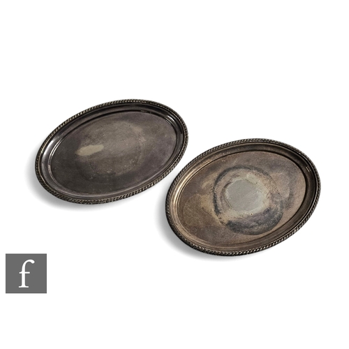 459 - A pair of later 20th Century silver oval stands or salvers, each with a simple gadroon border, width... 