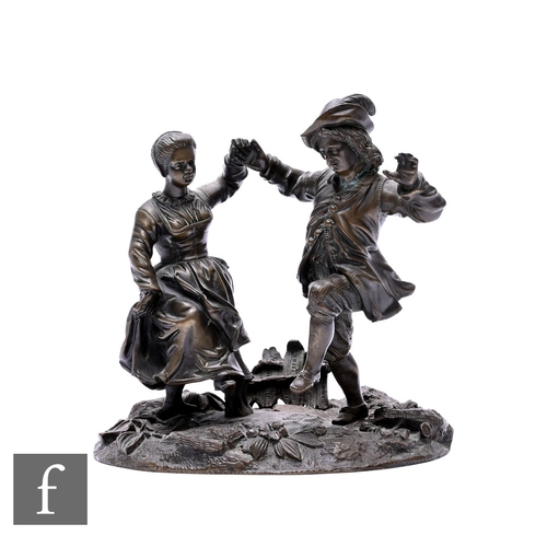 529 - A 19th Century French bronze study of two dancing French characters on a floral oval base near a gat... 