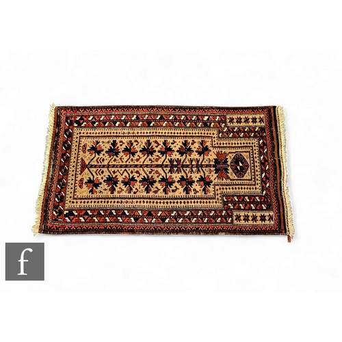 559 - A 19th Century Belouch camel hair prayer rug, natural brown dyed black, with central design, 120cm x... 