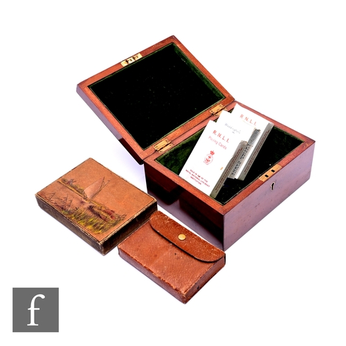 523 - Various playing cards contained in a small mahogany box, width 19cm.